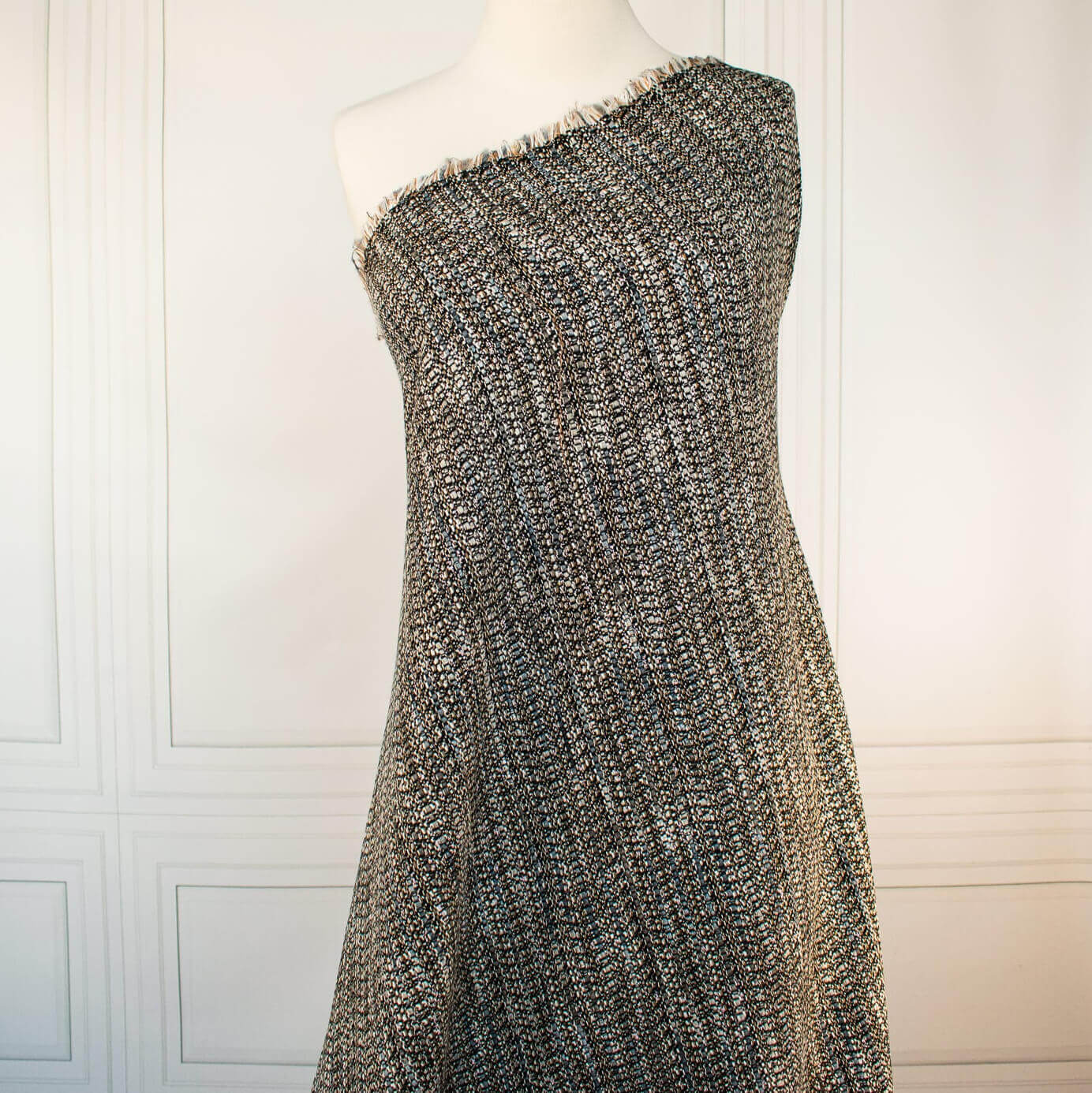 Couture Designer Italian Wool Boucle fabric draped on dressform against a white background.