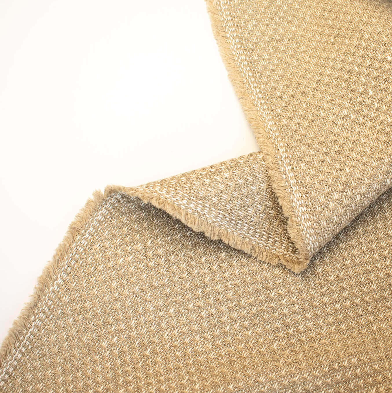Close-up of Couture Designer Golden Champagne Italian Wool Woven fabric  on a white background