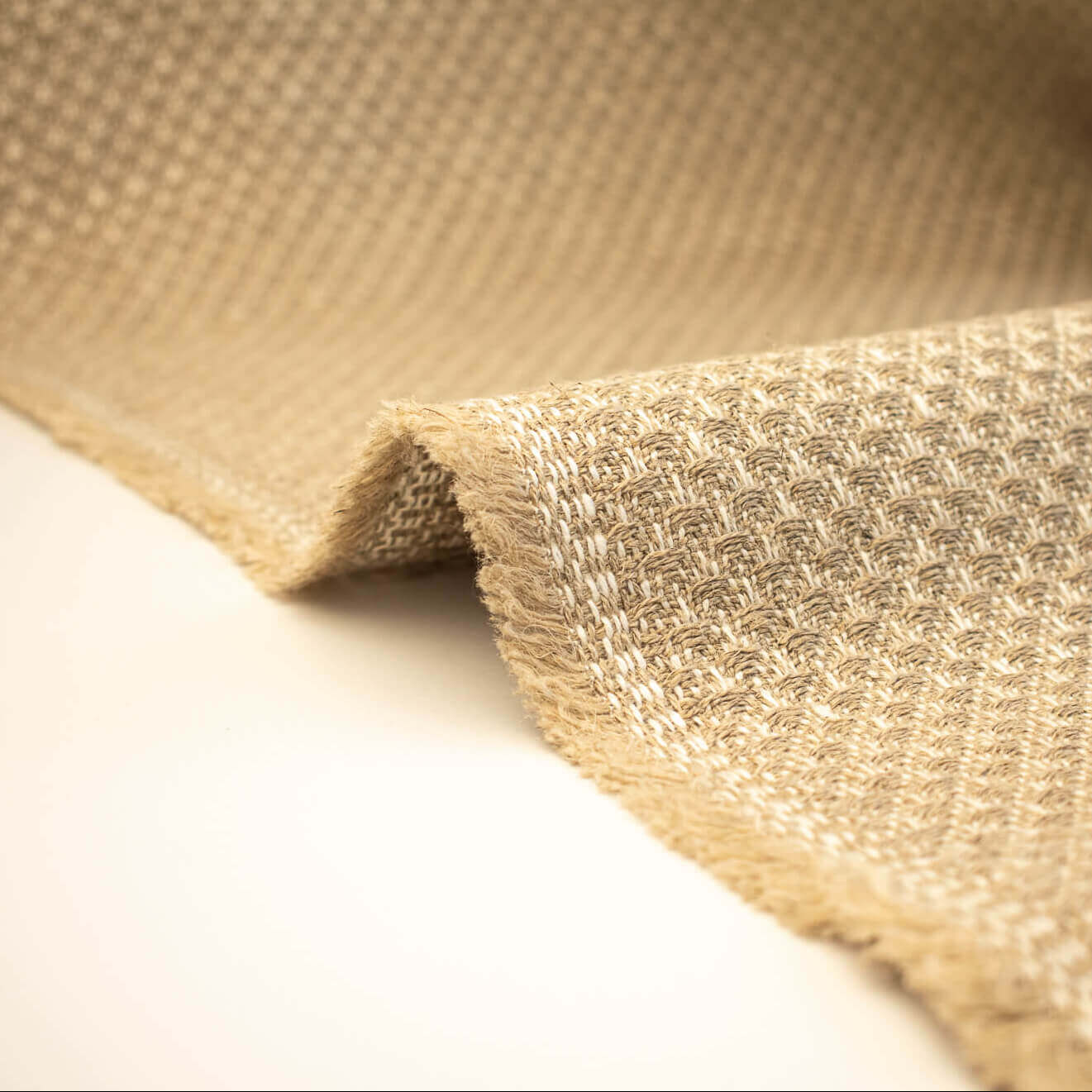 Close-up of Couture Designer Golden Champagne Italian Wool Woven fabric on a white background