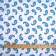 Image of Italian Blue and white paisley print cotton woven fabric with ruler for scale.