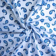 Image of Italian Blue and white paisley print cotton woven fabric demonstrating fabric fullness.