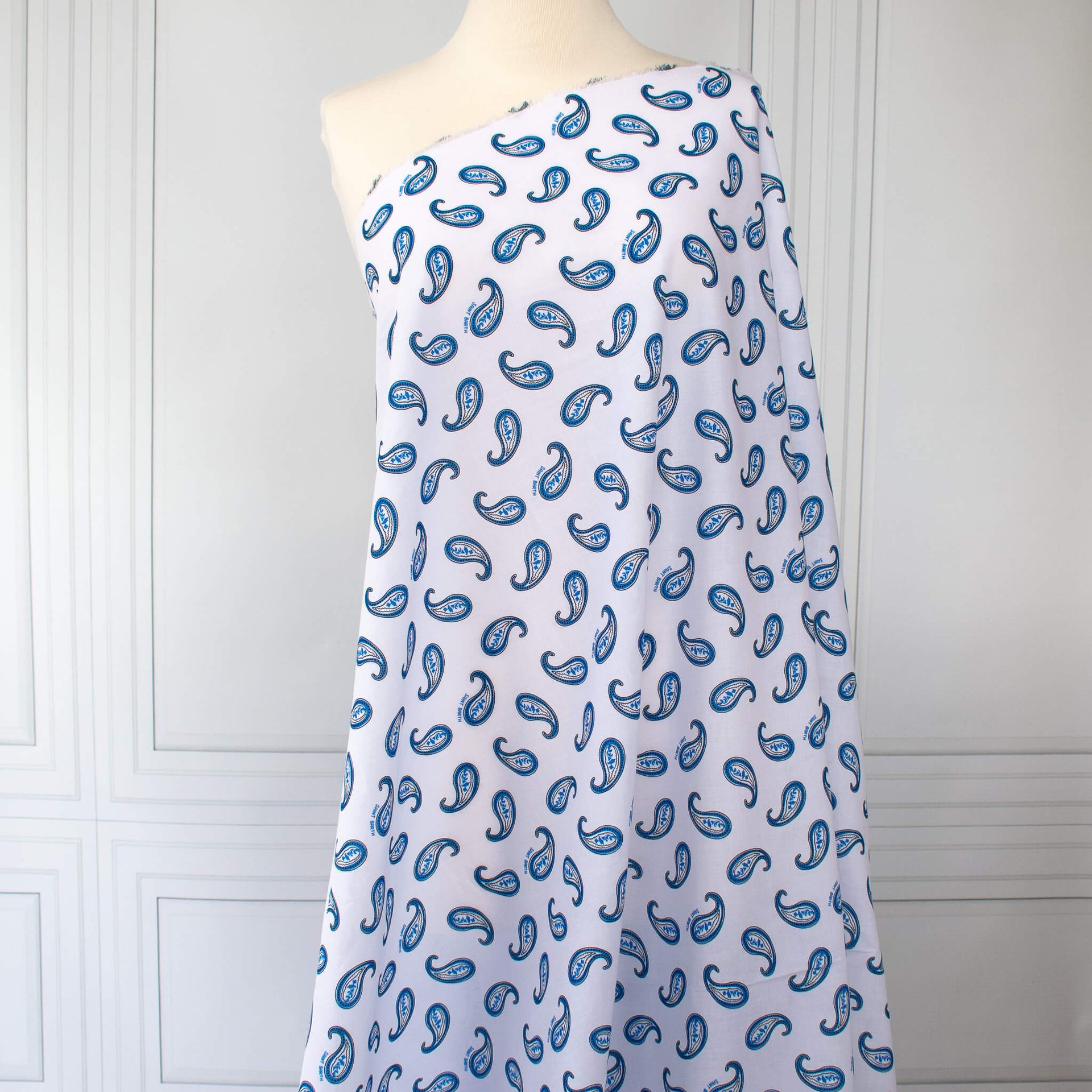 Image of Italian Blue and white paisley print cotton woven fabric on dressform.