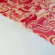 Italian Viscose Coral Red Paisley woven fabric by the yard. Image of selvedge.