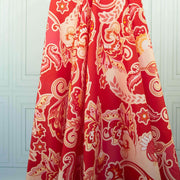 Image of Italian Viscose Coral Red Paisley woven fabric by the yard draped on dress form 