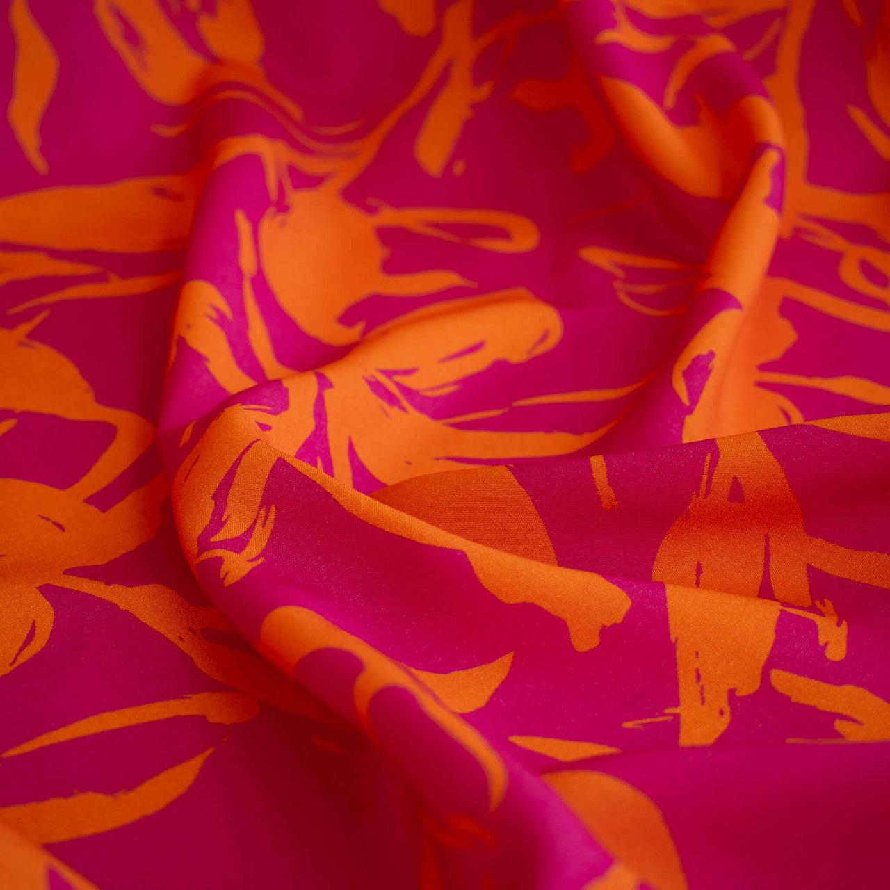 A close-up of  Italian Viscose fabric by the yard in a tropical leaf print.