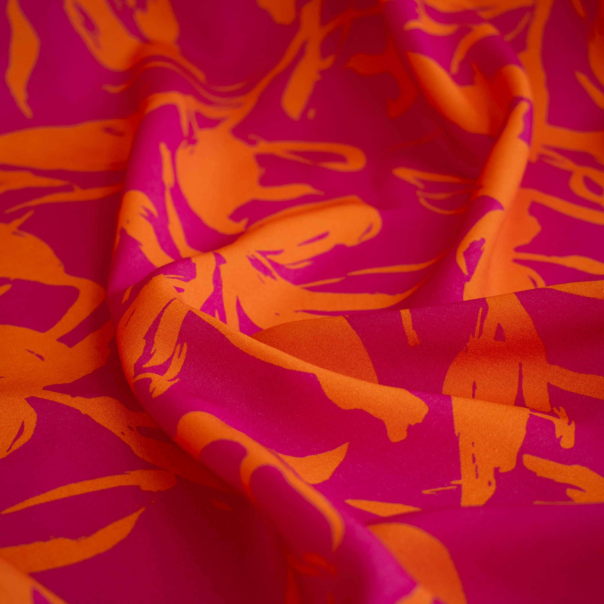 A close-up of  Italian Viscose fabric by the yard in a tropical leaf print.