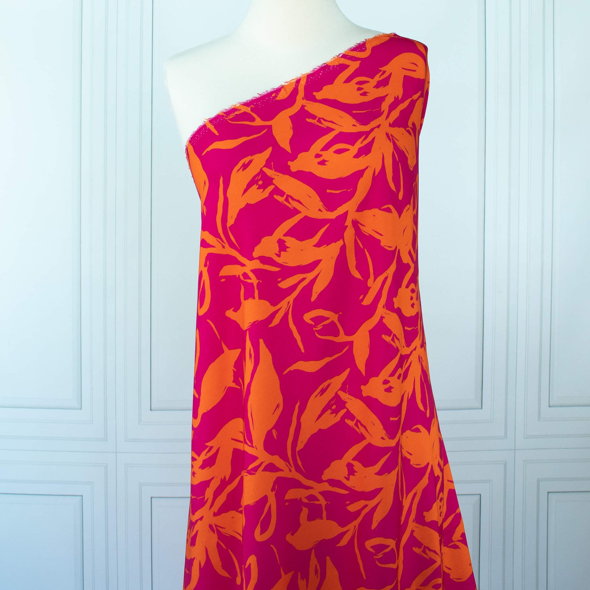  Italian Viscose fabric by the yard in a tropical leaf print drapedon dress form.
