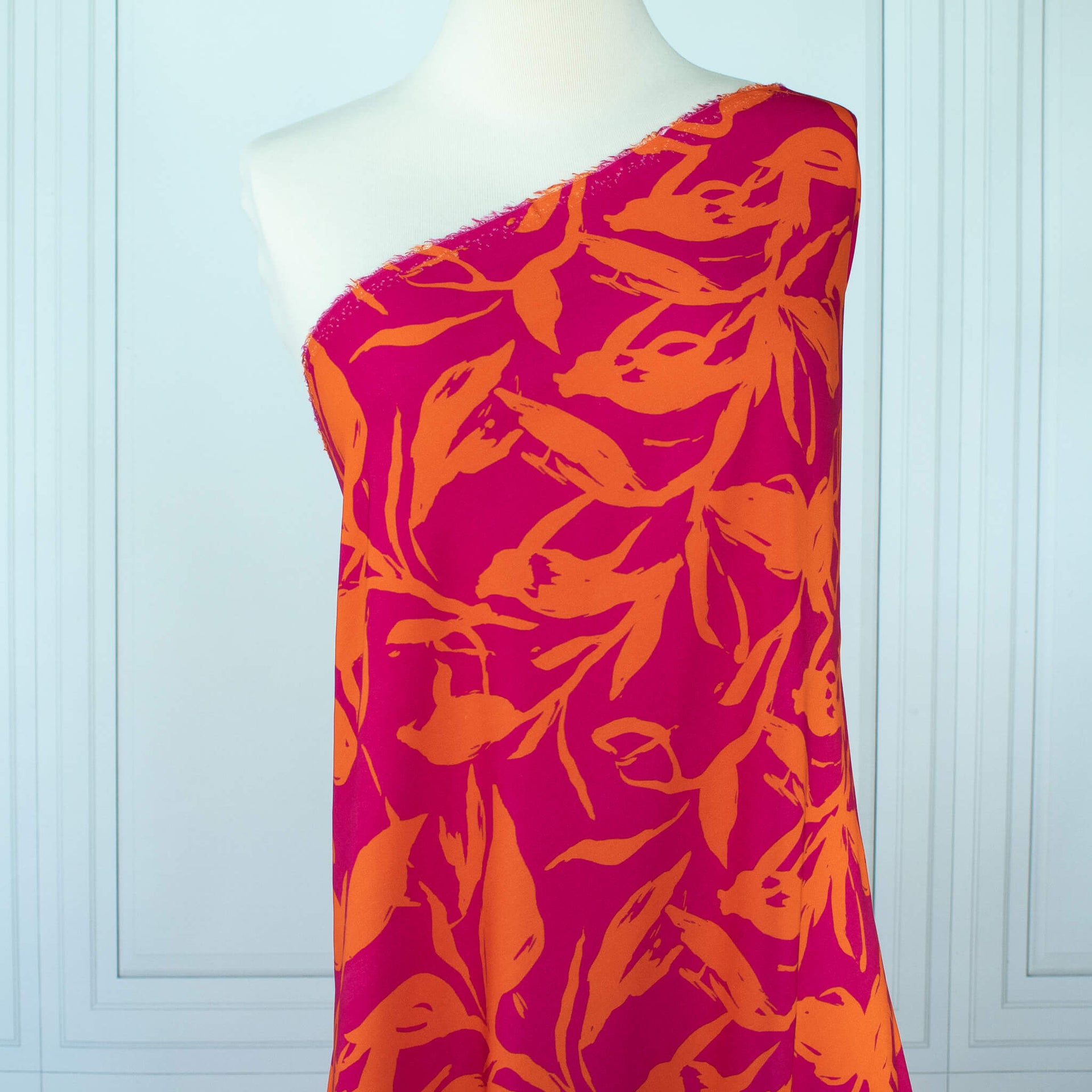  Italian Viscose fabric by the yard in a tropical leaf print draped on dress form.