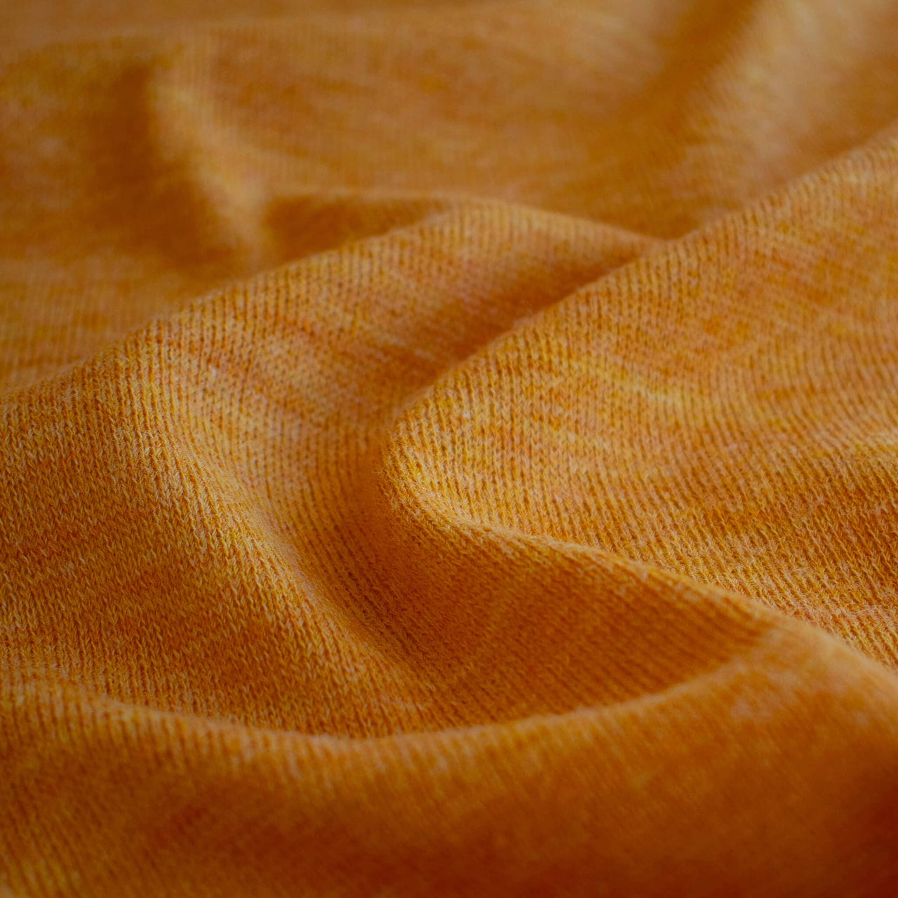 Close up image of Fine Italian Wool Knit Jersey fabric by the yard in golden saffron.