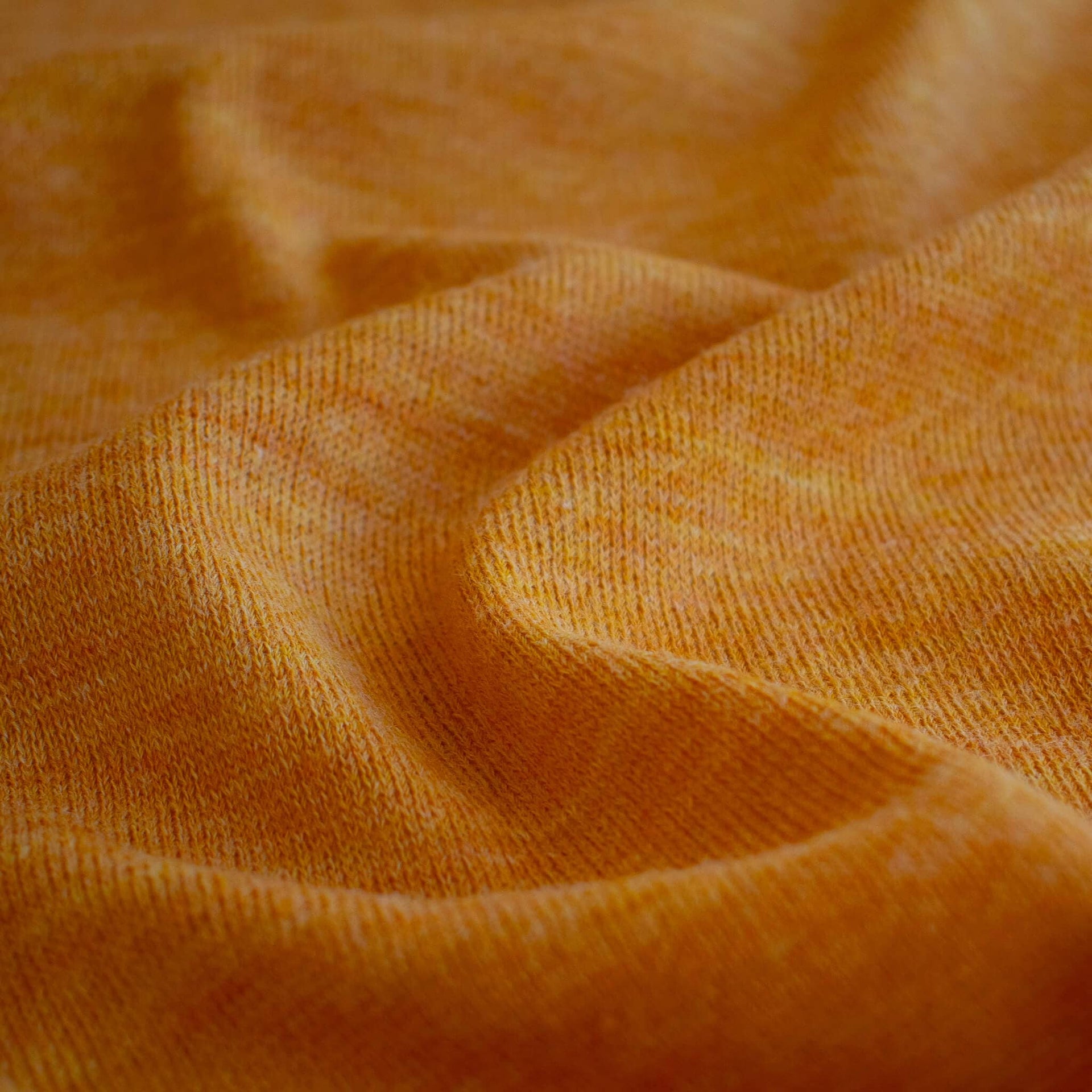 Close up image of Fine Italian Wool Knit Jersey fabric by the yard in golden saffron.