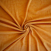 Fine Italian Wool Knit Jersey fabric by the yard in golden saffron. Image of fabric fullness.