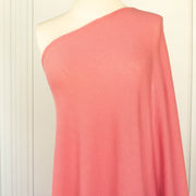 Image of Fine Italian Wool Jersey knit fabric in Pink Blush draped on dress form.