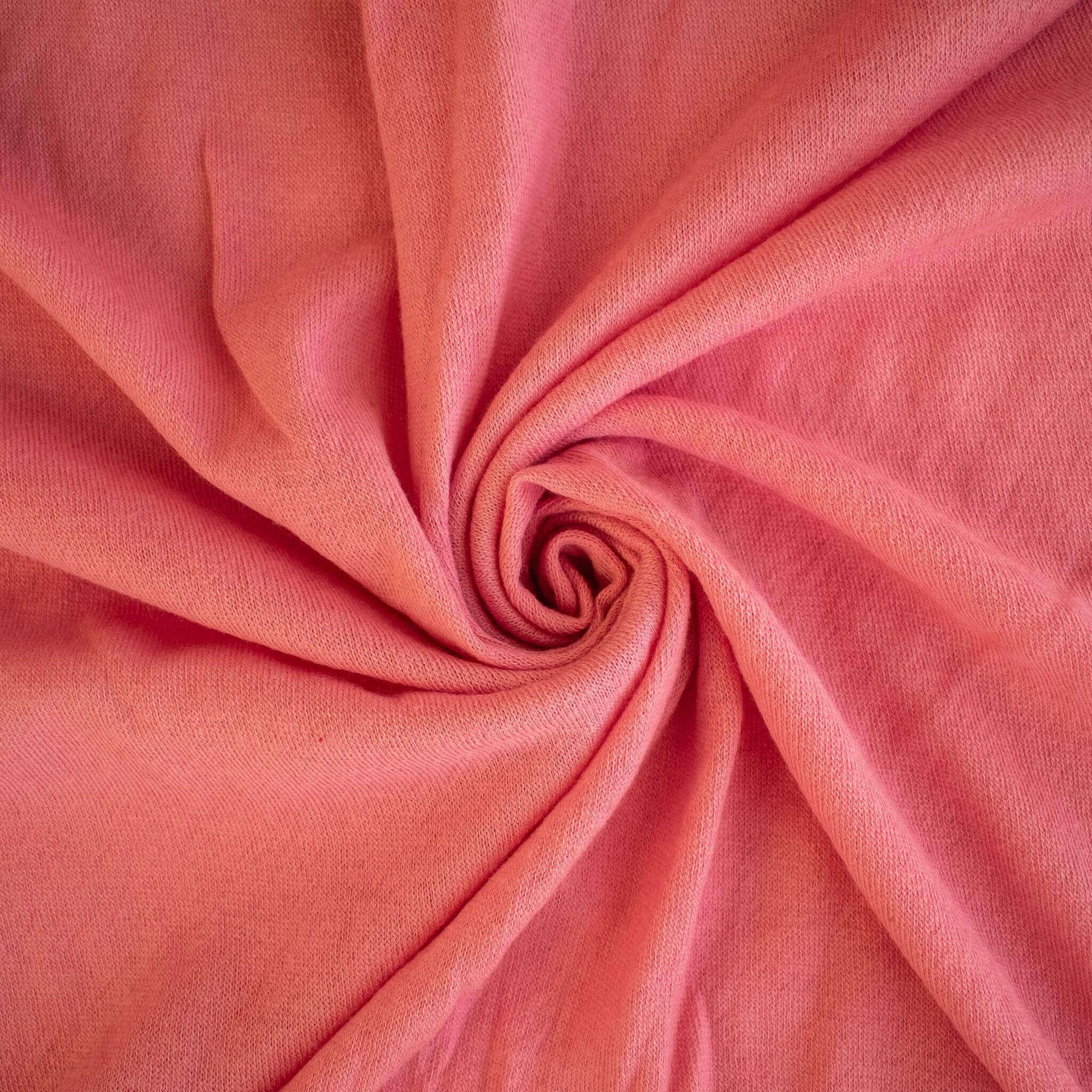Image of Fine Italian Wool Jersey knit fabric in Pink Blush swirled  to show fabric fullness
