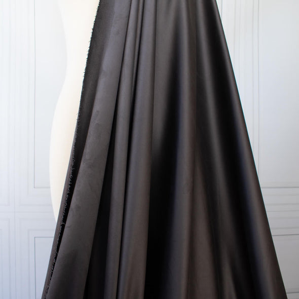 Faux Suede Knit fabric by the yard in a neutral truffle brown color . It has a soft hand, elegant drape and tons of edgy sophistication! Faux suède has a soft napped surface which requires cutting your fabric out in a one-way nap direction. Image of fabric  drape.