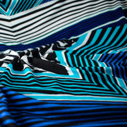 Italian Abstract knit fabric by the yard. The soft hand and gorgeous drape is comfortable and stylish. Be your own designer and create something uniquely your own by taking advantage of the figure flattering print design! Close up image of fabric.