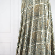 Italian Geometric Animal Print knit fabric by the yard directly from Ratti, the renowned mills know for its excellence in textiles. The elegant shades of browns and tans make it perfect for a sophisticated knit top or as a versatile choice for the latest designer wrap dress. Image of fabric drape