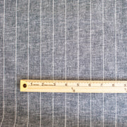 Cotton/Linen Chambray fabric by the yard. On the lighter side of mid-weight, this woven dark navy chambray features a white vertical pinstripe, a nice comfortable hand, and a lovely drape.  Image of pattern scale with ruler.