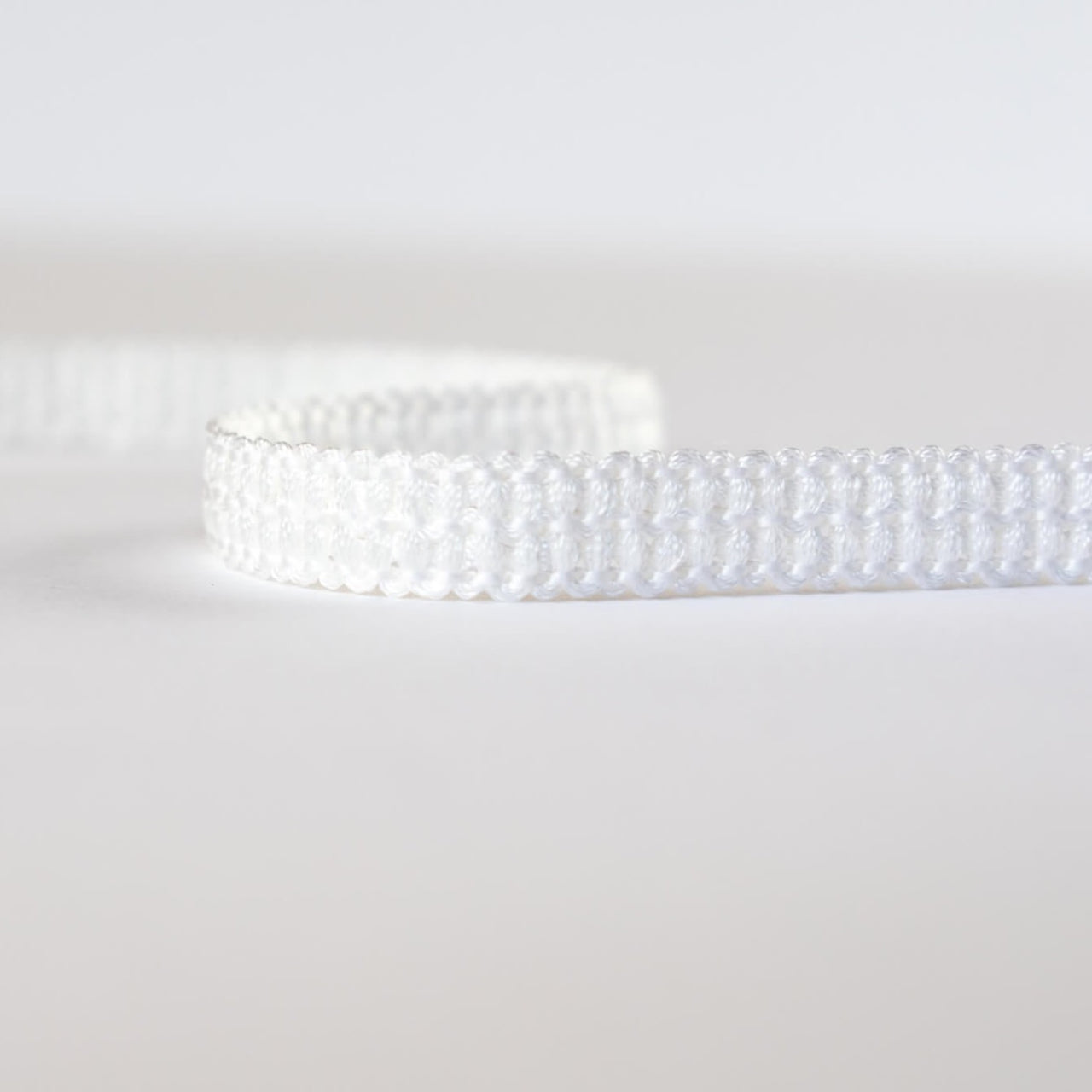 Mokubba Ivory Passenmenterie in soft white close up. Perfect trim to add a couture touch.