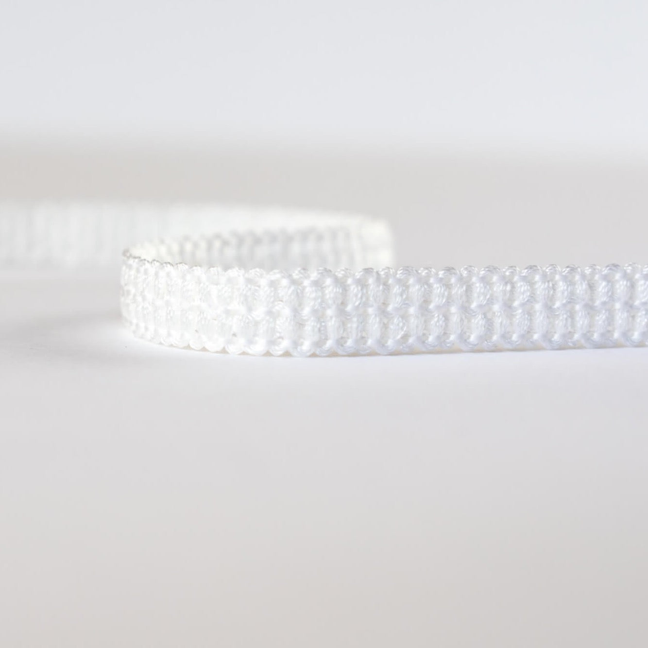 Mokubba Ivory Passenmenterie in soft white close up. Perfect trim to add a couture touch.