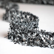 Exquisite Mokuba passementerie trim in black and silver chenille ribbons perfect for your next couture classic French jacket. Close up picture