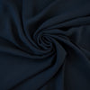 Become a fashionista with this NYC designer 100% silk double georgette Prussian blue fabric by the yard. A designer deadstock fabric that is flowy, with a textured hand, and can be cut on the bias for a stunning top, dress, or skirt!  Image of fabric body.