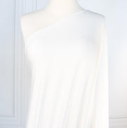 Los Angeles Designer modal jersey knit deadstock fabric by the yard is sustainability at its best. A soft and smooth off-white knit fabric with a cool hand and fluid drape, perfect for a T-shirt, camisole, or loungewear. Image of fabric on dressform.