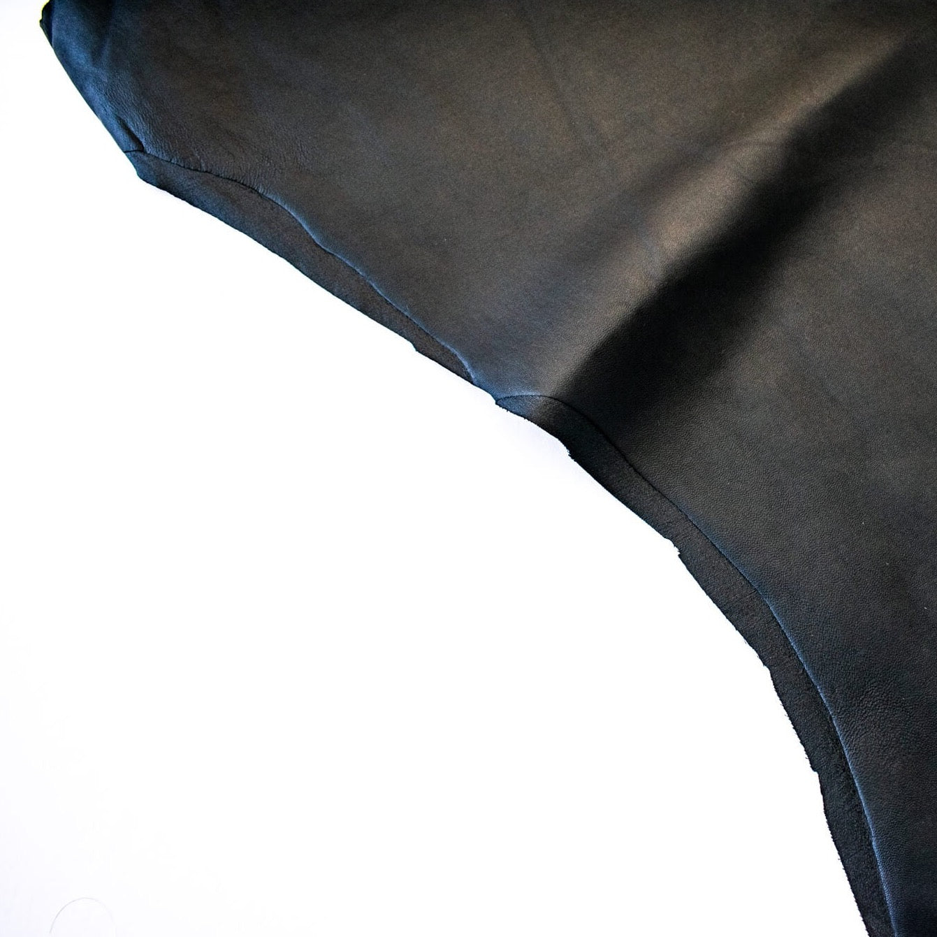 Take you wardrobe to the next level with our Black Lambskin stretch leather. Popular with designers, it is perfect for those looking for a sophisticated and exclusive look.  Indulge yourself in its soft and supple texture, with just the right amount of stretch for exceptional comfort. Image of fabric edge.