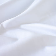 High-End Designer White Cotton Fine Twill fabric by the yard. Simple elegance at its finest from a Los Angeles designer that has a knack for finding luxurious fabrics. Close up image.