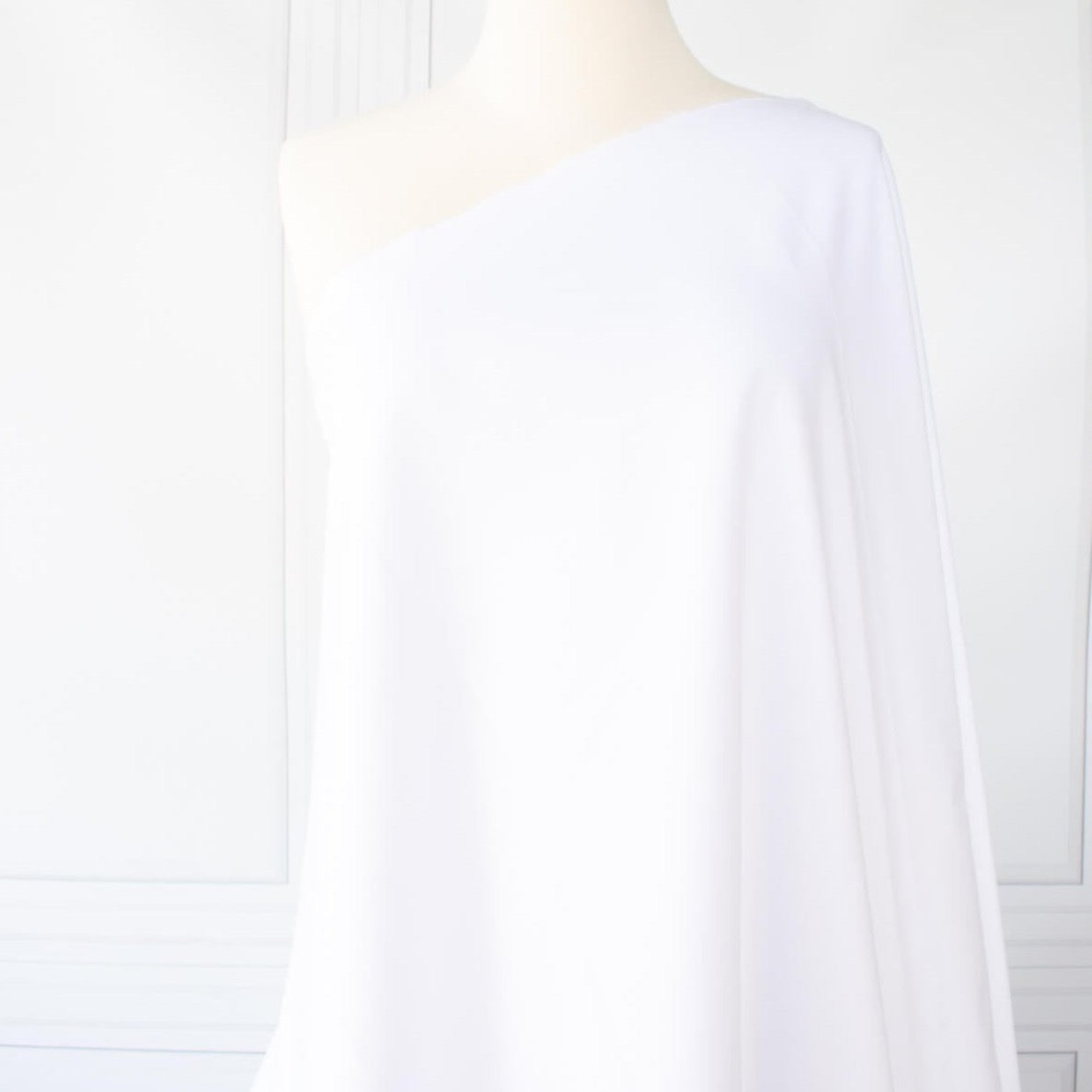 High-End Designer White Cotton Fine Twill fabric by the yard. Simple elegance at its finest from a Los Angeles designer that has a knack for finding luxurious fabrics. Image of fabric draped on dressform.