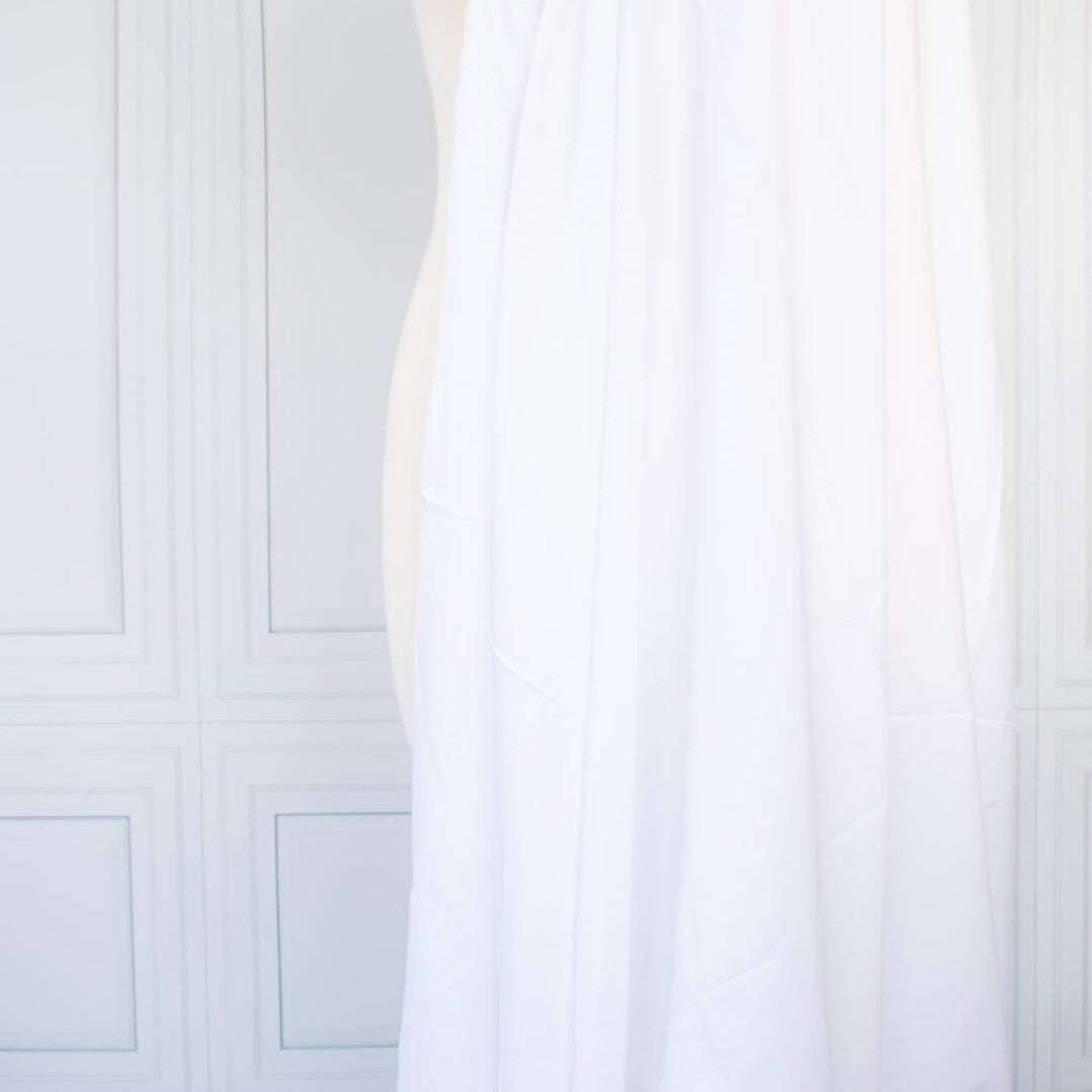 High-End Designer White Cotton Fine Twill fabric by the yard. Simple elegance at its finest from a Los Angeles designer that has a knack for finding luxurious fabrics. Image of fabric drape.