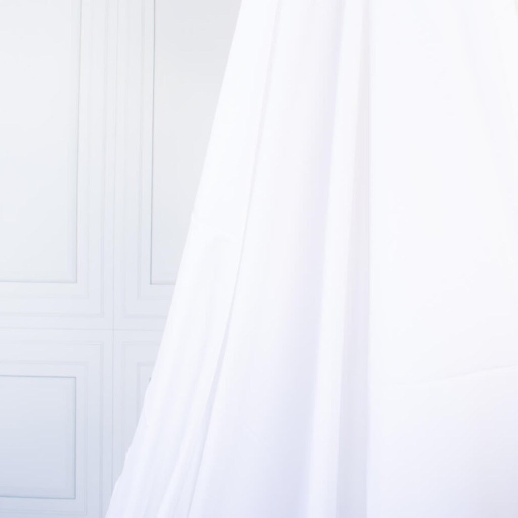 High-End Designer White Cotton Fine Twill fabric by the yard. Simple elegance at its finest from a Los Angeles designer that has a knack for finding luxurious fabrics. Image of fabric drape.