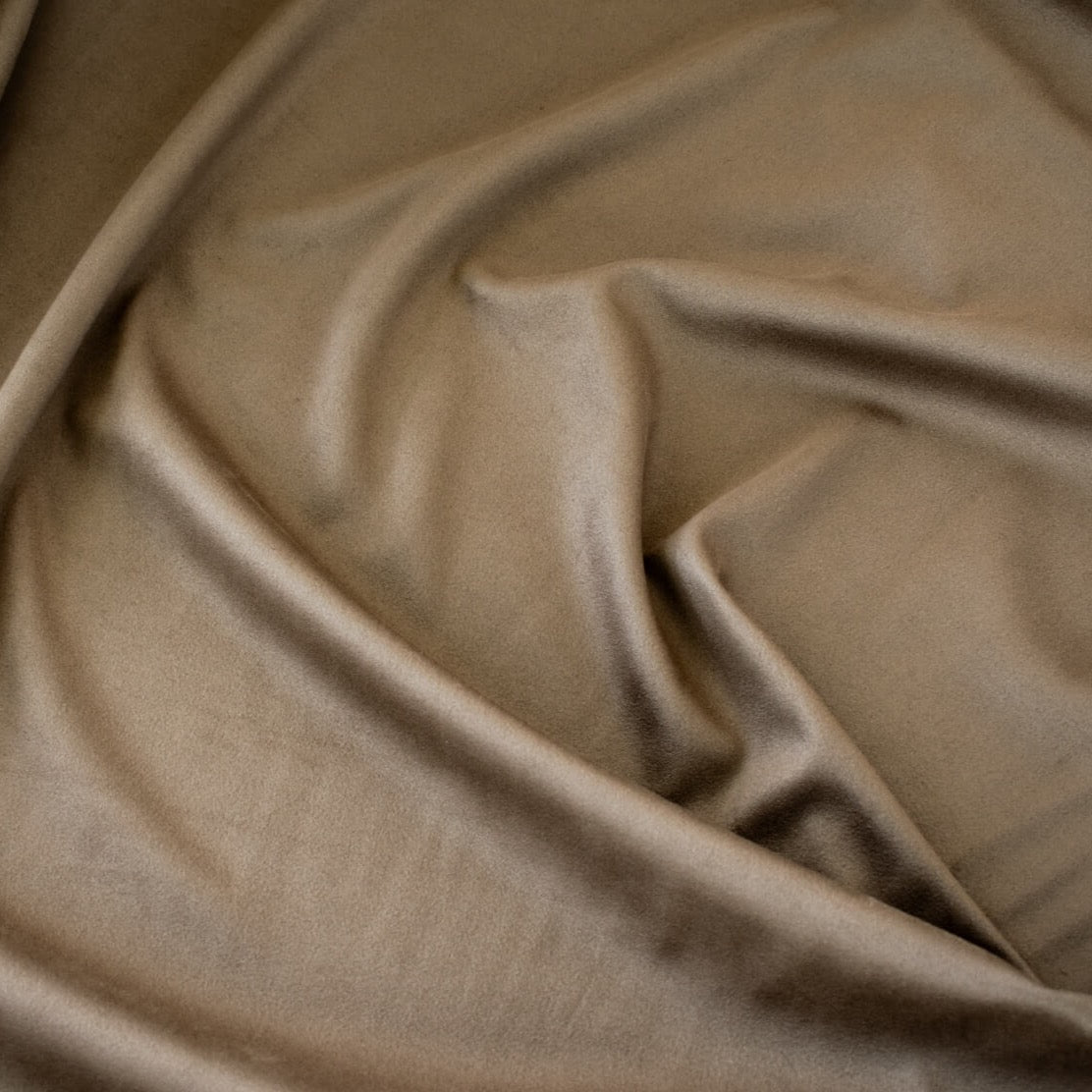 Take your projects up a notch with our Faux Suede Knit fabric by the yard in a soft brown we call "Haute Chocolate". Luxuriously smooth and endlessly fabulous, it's the perfect fabric to add a subdued edge to your "Haute" look! Close up image