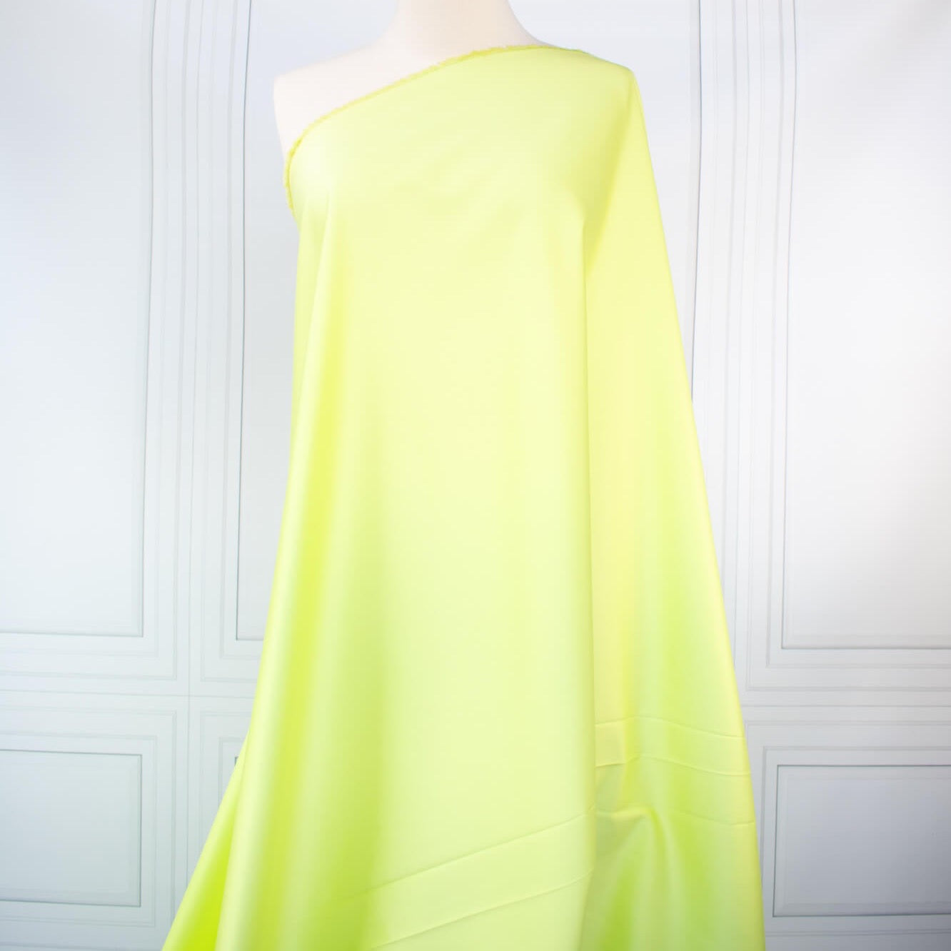 Have some fun in this delightful soft lime green cotton sateen fabric by the yard. Perfect when you want to add a bit of pizzazz to your outfit. The soft lightly brushed hand with the slightest sheen would sew up a lovely shirtdress, &nbsp;jacket or ankle length pant! Image of fabric on dressform.