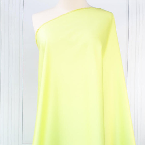Have some fun in this delightful soft lime green cotton sateen fabric by the yard. Perfect when you want to add a bit of pizzazz to your outfit. The soft lightly brushed hand with the slightest sheen would sew up a lovely shirtdress, &nbsp;jacket or ankle length pant! Image of fabric on dressform.