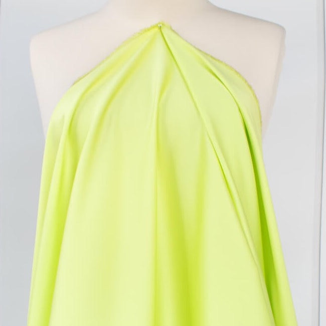 Have some fun in this delightful soft lime green cotton sateen fabric by the yard. Perfect when you want to add a bit of pizzazz to your outfit. The soft lightly brushed hand with the slightest sheen would sew up a lovely shirtdress, &nbsp;jacket or ankle length pant! Image of fabric drape.