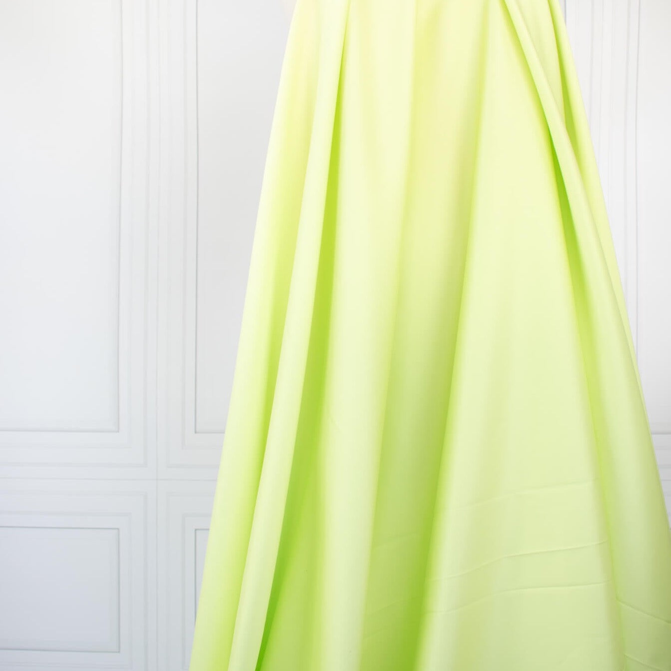 Have some fun in this delightful soft lime green cotton sateen fabric by the yard. Perfect when you want to add a bit of pizzazz to your outfit. The soft lightly brushed hand with the slightest sheen would sew up a lovely shirtdress, &nbsp;jacket or ankle length pant! Image of fabric drape.