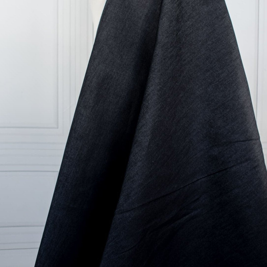 Get the perfect blend of comfort and style with our Midnight Navy Cotton Stretch Denim Twill fabric by the yard. &nbsp;A denim you can dress up with its deep rich dark blue color and crisp, semi-textured hand.  Image of fabric drape.