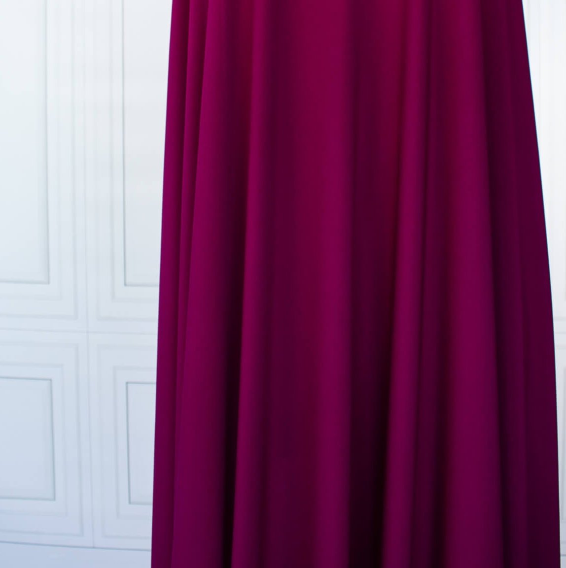 Famous Designer Poly/Spandex ITY Knit in 'Berry Rich'! This designer deadstock fabric by the yard boasts a rich berry color that is sure will elevate any project. Its smooth hand and elegant drape is a must have for comfort and style. Image of fabric drape.