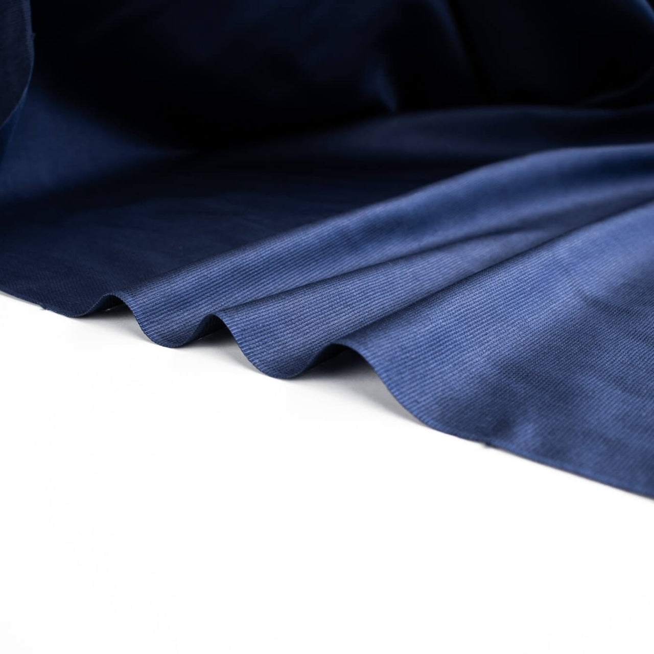 Fine Egyptian Pima Cotton Pique Shirting fabric by the yard. Imported from Switzerland, our fabric boasts a luxurious cotton that is semi-sheer and has a soft, semi-crisp hand. Perfect for a high-end and comfortable shirt, dress, skirt or top!  Image of selvedge.