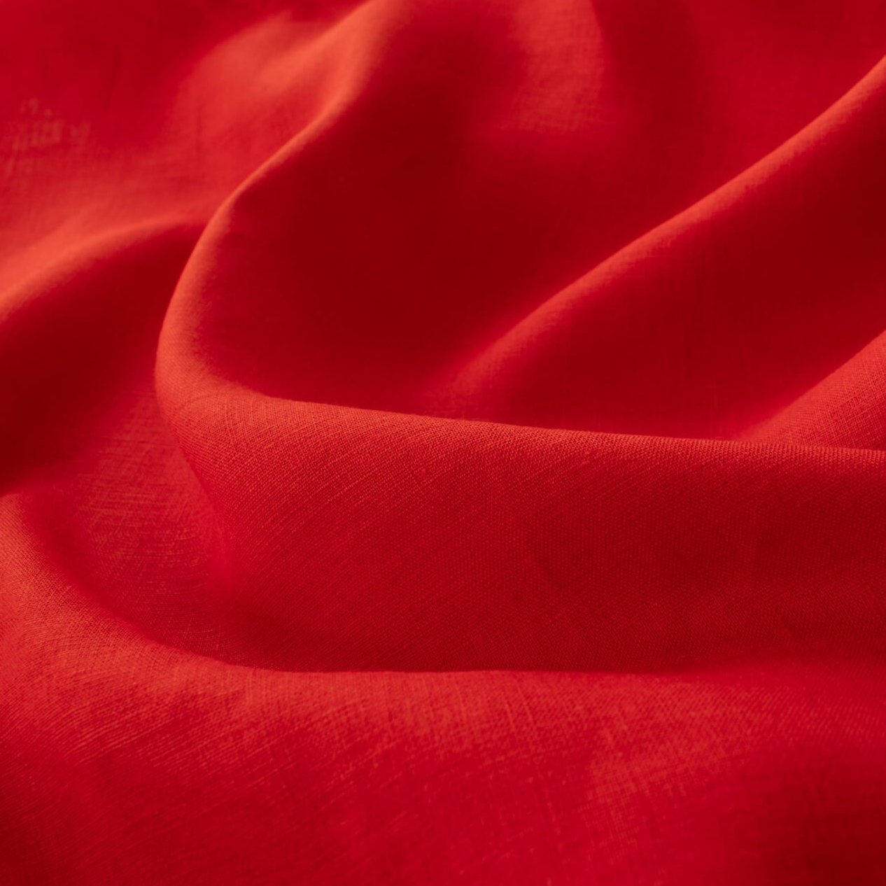 Red mid-weight linen fabric by the yard is just plain gorgeous. The fabric has a soft hand, slight slubbing, and the mid-weight makes it a perfect choice for tailored garments such as jackets and fitted sheath dresses or suitings.Close up image.