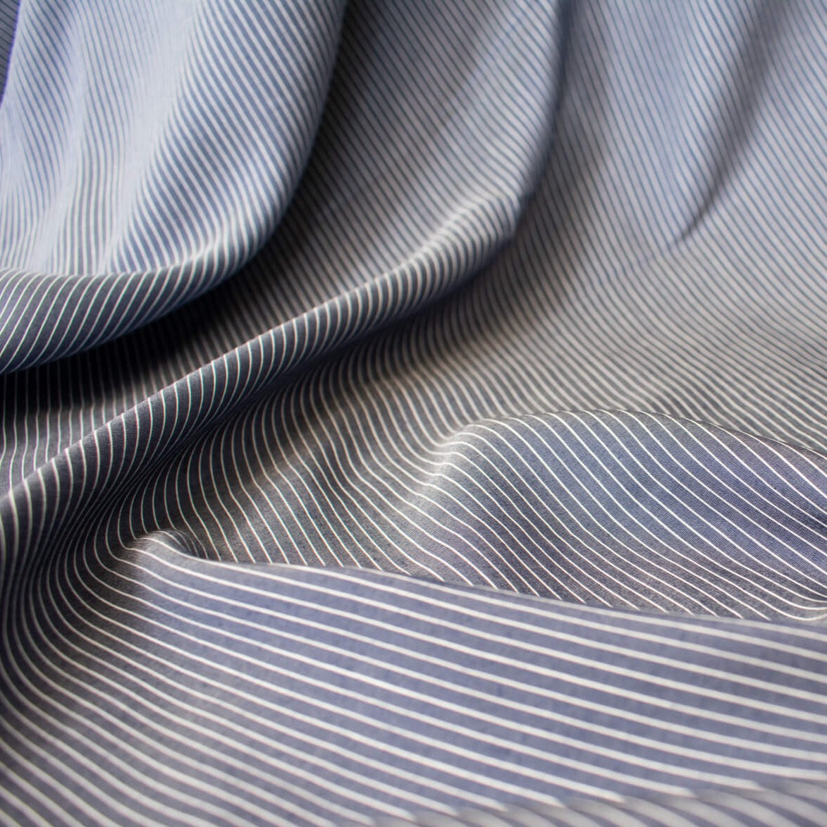 NYC Designer Deadstock Cotton Voile fabric by the yard. Amazingly soft and silky, this Navy/White horizontal stripe voile is lightweight with a thin hand, a must for warmer temperatures. Close up image
