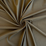 This elegant NYC Designer Pinstripe Twill designer deadstock fabric by the yard is the perfect choice for those who appreciate understated elegance. The gorgeous combination of tan highlighted by a white pinstripe features a soft, textured hand and falls moderately away from the body. A perfect choice if you will be sewing up a trouser, or suiting. Image of fabric fullness.