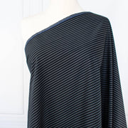 NYC Designer Dark Navy/White Striped Cotton/Spandex Shirting fabric by the yard in a midnight blue is a perfect staple when building your wardrobe pieces. This designer deadstock fabric boasts a soft and smooth hand, is tightly woven and enhanced with a touch of stretch.  Image of fabric draped on dressform.