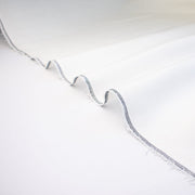 NYC Designer Linen blend designer deadstock fabric by the yard is the perfect fabric if you just love linen. &nbsp;A plain weave off-white fabric with a soft, slightly crisp hand.  Close up selvedge image.