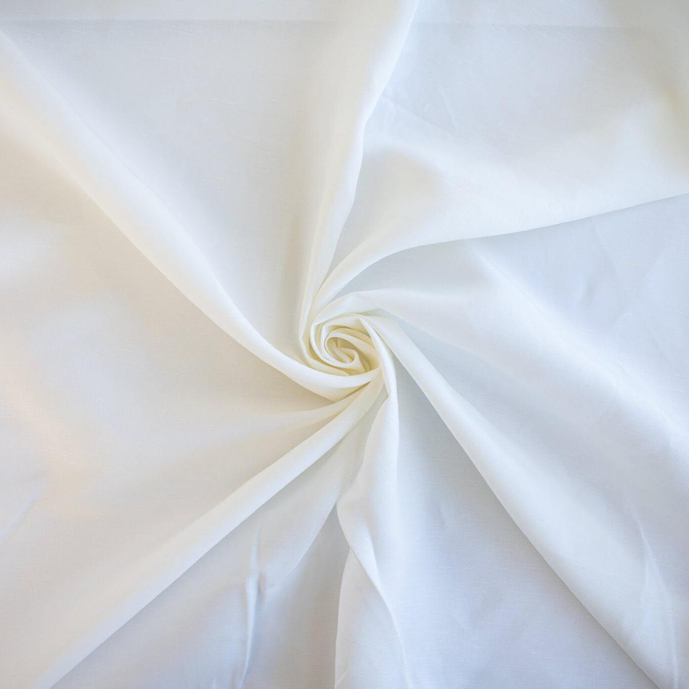 NYC Designer Linen blend designer deadstock fabric by the yard is the perfect fabric if you just love linen. &nbsp;A plain weave off-white fabric with a soft, slightly crisp hand.  Image of fabric fullness.
