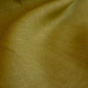 100% Linen Mid-Weight Woven fabric by the yard in a&nbsp;gorgeous golden green is a stunner and perfect for warmer weather. This plain weave linen is soft and has a crisp semi-textured hand. Create a lovely Jacket, Pant, Tunic or Vest! Close up image