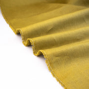 100% Linen Mid-Weight Woven fabric by the yard in a&nbsp;gorgeous golden green is a stunner and perfect for warmer weather. This plain weave linen is soft and has a crisp semi-textured hand. Create a lovely Jacket, Pant, Tunic or Vest! Image of selvedge.