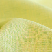 Made of 100% linen, this shirt-weight fabric features a gentle blend of spring green, white, and soft yellow tones, perfect for a stylish shirt, dress or skirt. Enjoy the lightweight, soft semi-crisp hand of this cross-dyed, woven fabric. Close up image of fabric weave.