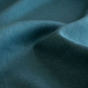 Harbor Blue 100% Linen shirt-weight woven fabric by the yard. Enjoy the soft and crisp hand and beautiful harbor blue hue that is sure to be a fantastic color to wake up your neutral pieces. Clise up image.