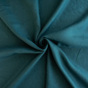 Harbor Blue 100% Linen shirt-weight woven fabric by the yard. Enjoy the soft and crisp hand and beautiful harbor blue hue that is sure to be a fantastic color to wake up your neutral pieces. Image of fabric fullness.